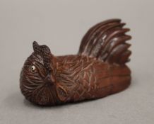 A signed netsuke formed as a chicken. 5.5 cm long.