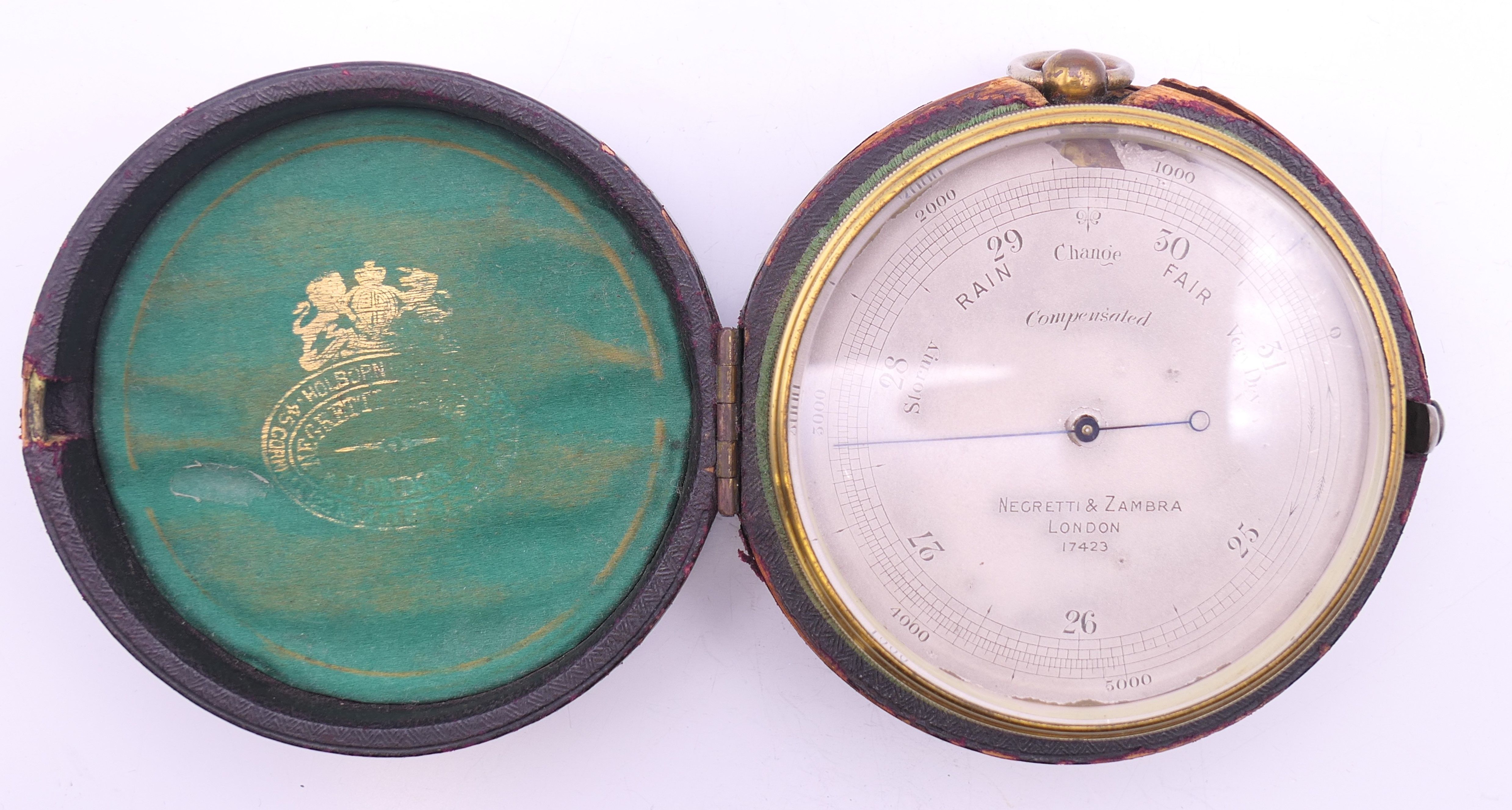 A Negretti & Zambra of London brass barometer, in original case, numbered 17423. 7 cm diameter. - Image 11 of 15