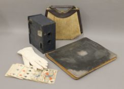 A box of miscellaneous items, including a dressing table set, a hand bag, playing cards, etc.
