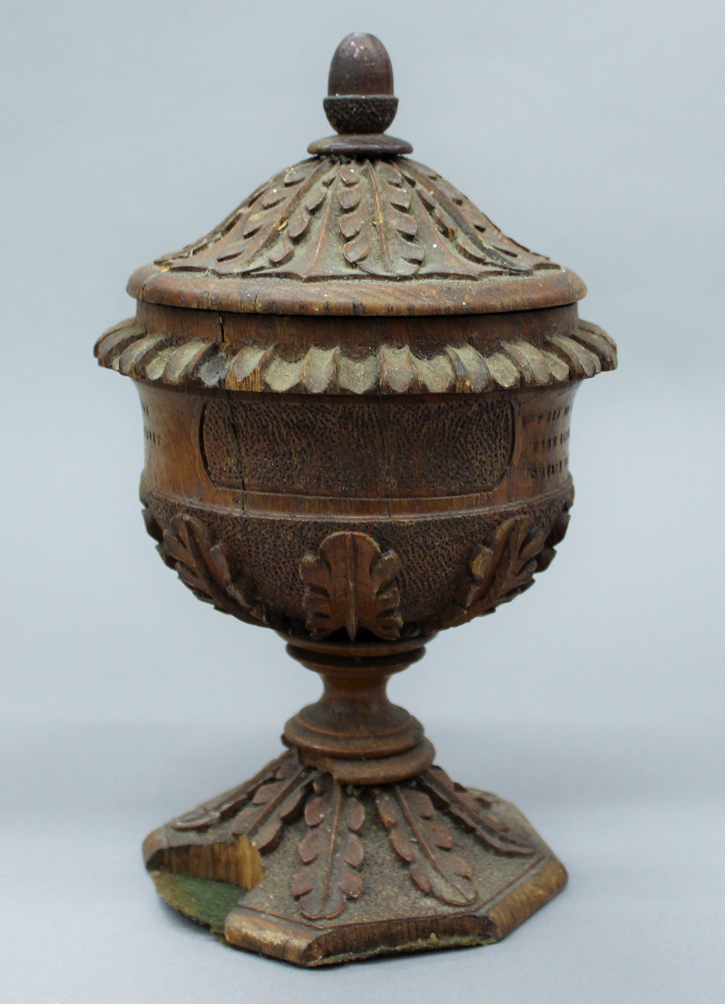 A carved oak cup and cover. 24 cm high.