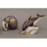 A Royal Crown Derby badger form paperweight and a Royal Crown Derby dolphin form paperweight.