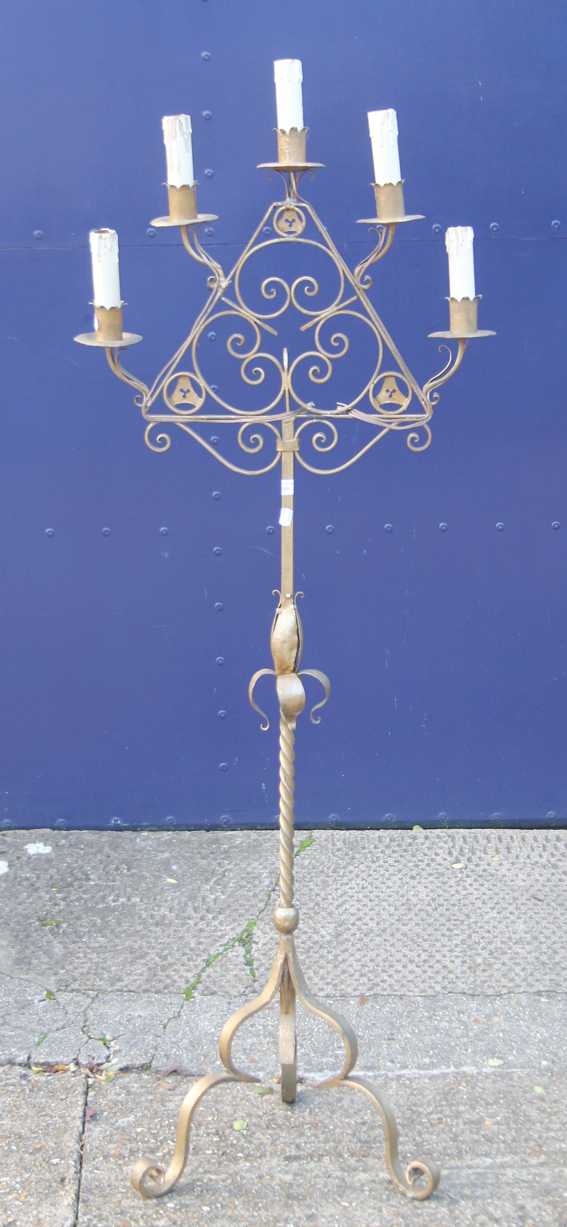 A wrought iron candelabra. 162 cm high.