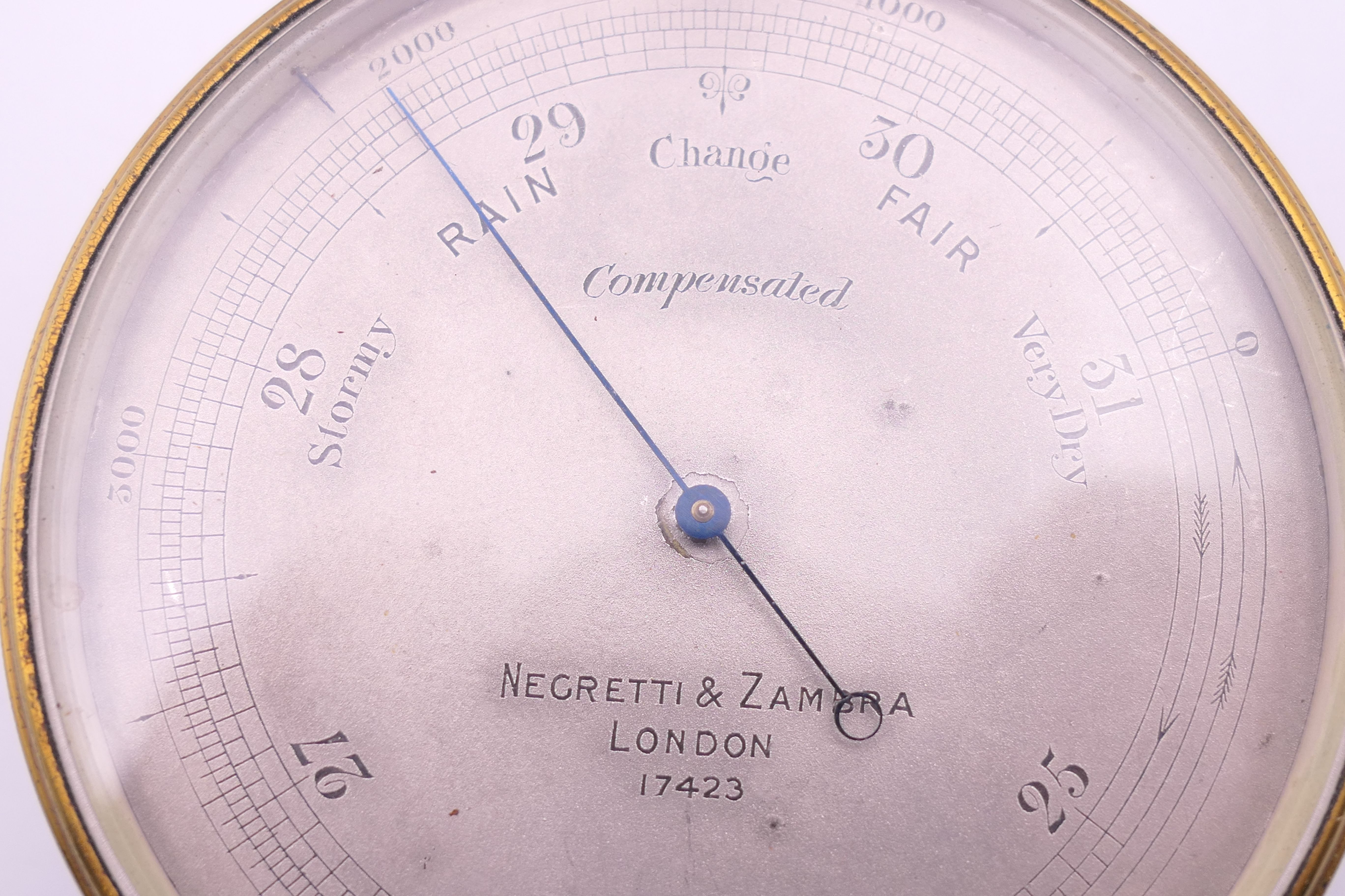 A Negretti & Zambra of London brass barometer, in original case, numbered 17423. 7 cm diameter. - Image 2 of 15