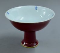 A Chinese red porcelain stem cup. 11.5 cm high.