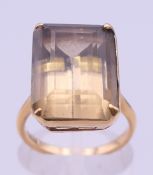 An 18 ct gold smoky quartz ring. Quart 1.75 x 1.25 cm. Ring size J/K. 7.1 grammes total weight.