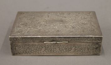 A Persian unmarked white metal cigarette box. 15 cm wide. 333.9 grammes total weight.