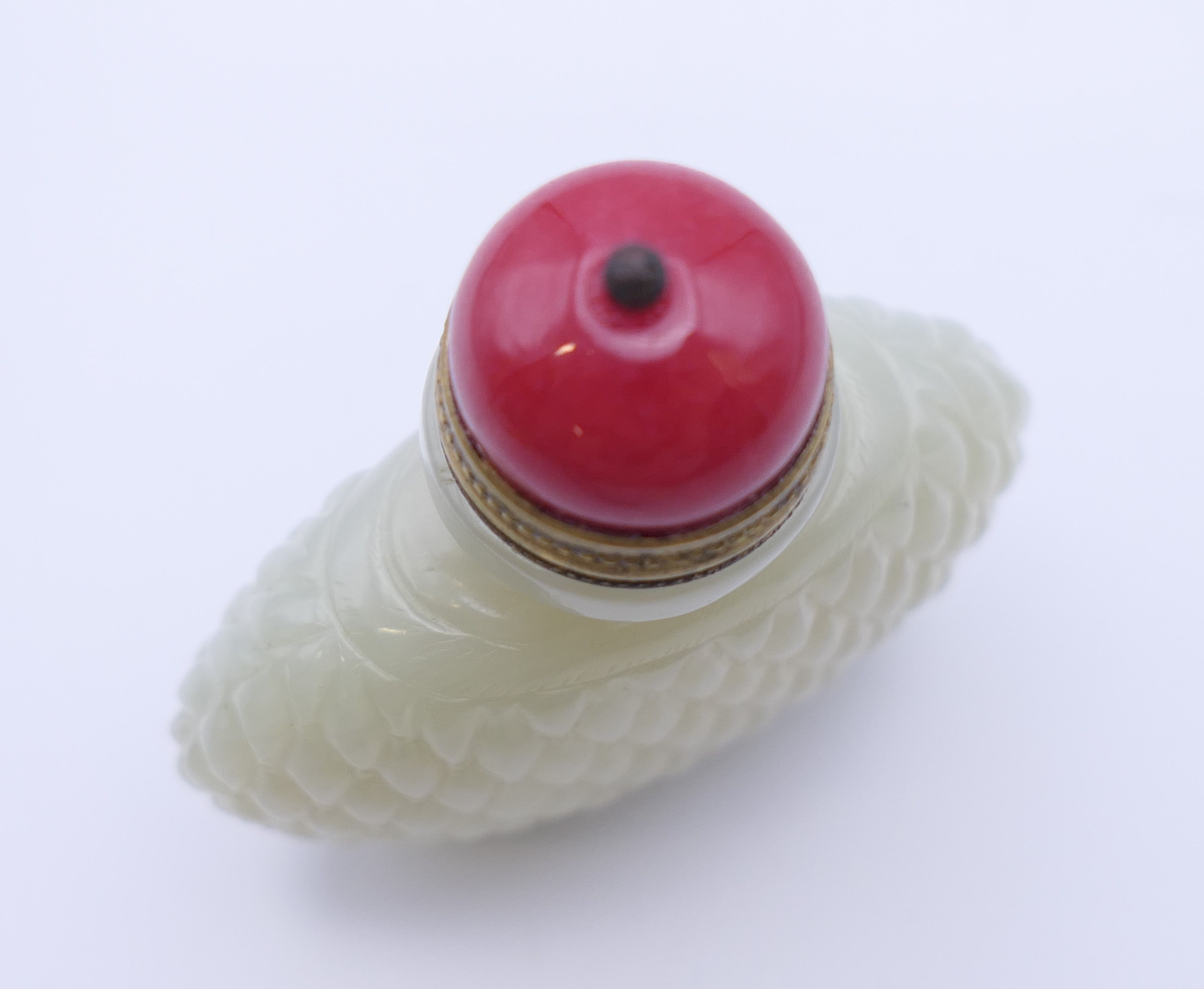 A Chinese white jade diamond cut pattern snuff bottle, with red stopper, Qing Dynasty. - Image 6 of 7