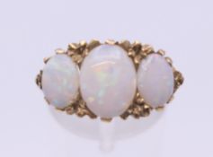 A 9 ct gold opal three stone ring. Ring size N/O. 4.6 grammes total weight.