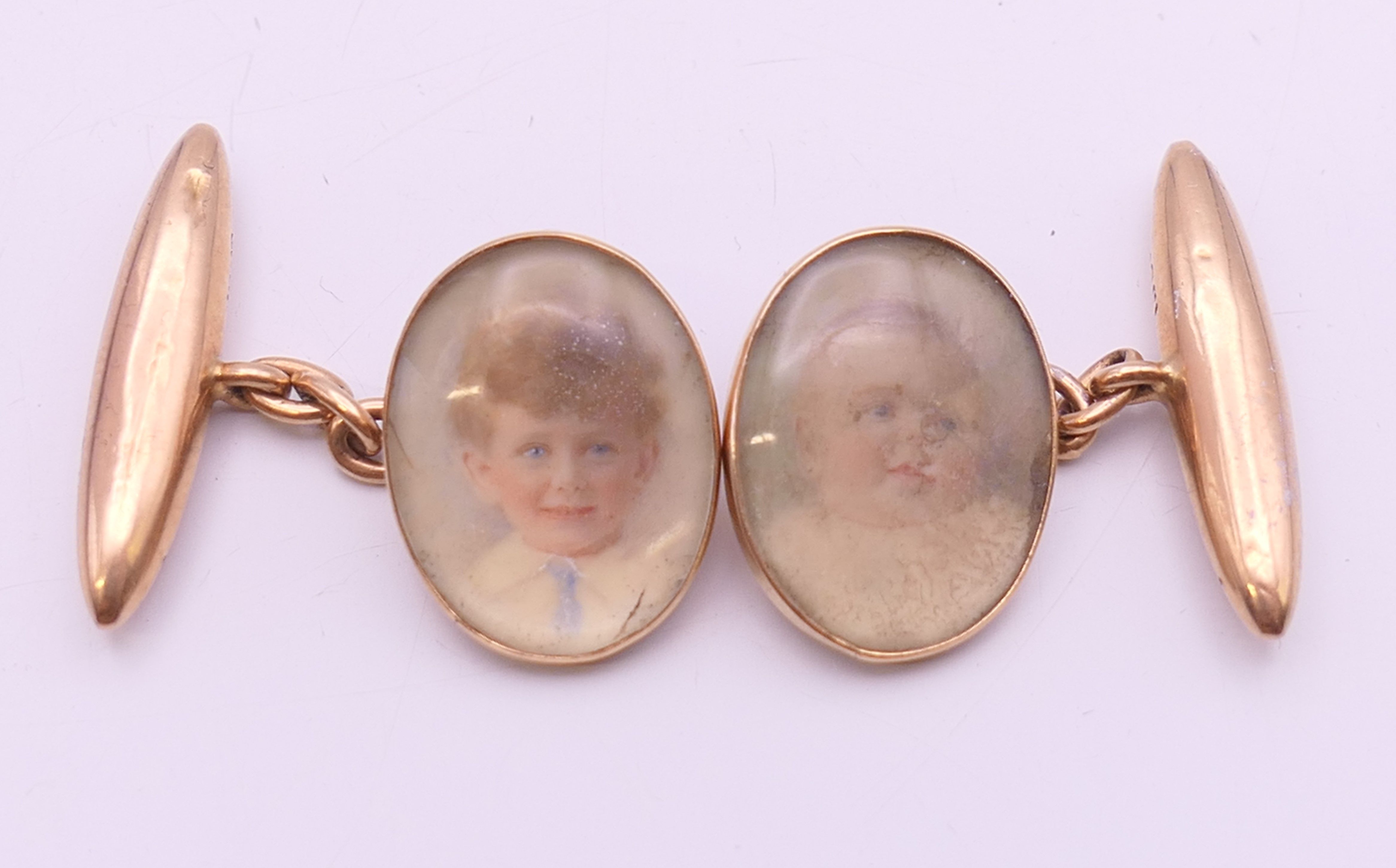 A pair of Victorian 15 ct gold cufflinks set with miniature portraits of children.