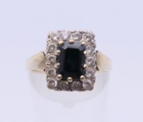 A 9 ct gold sapphire and diamond ring. Ring size L/M. 4.2 grammes total weight.