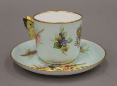 A Royal Worcester cup and saucer with a butterfly handle. The cup 6 cm high.