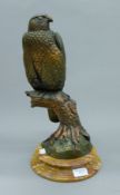 A bronze model of a falcon on a marble base. 41 cm high.