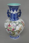 A Chinese porcelain vase decorated with boys and peaches. 36.5 cm high.