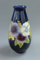 A Moorcroft style vase. 30 cm high.