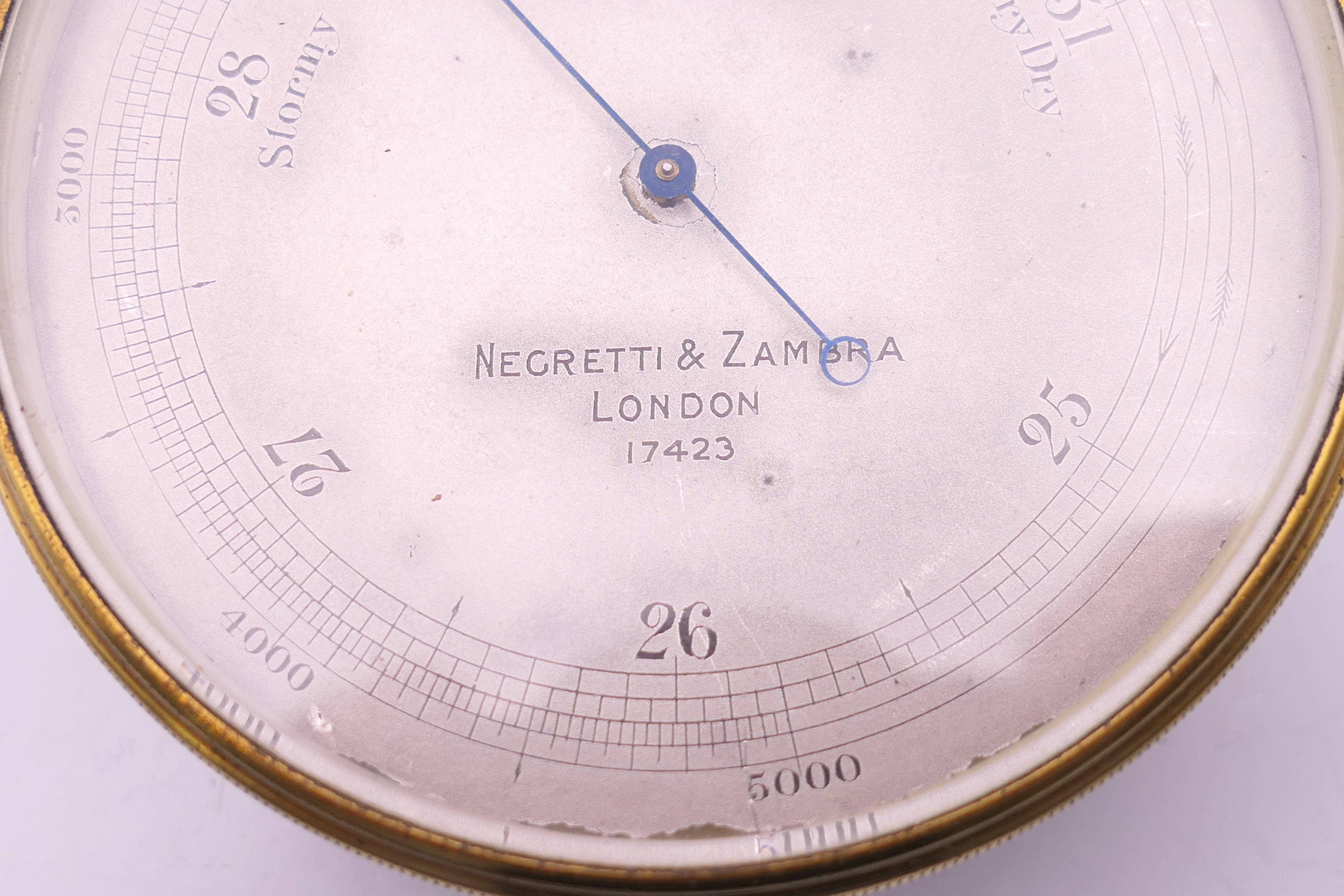 A Negretti & Zambra of London brass barometer, in original case, numbered 17423. 7 cm diameter. - Image 3 of 15