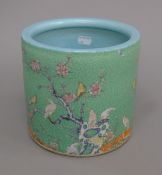 A Chinese green ground porcelain brush pot decorated with birds. 18 cm high.