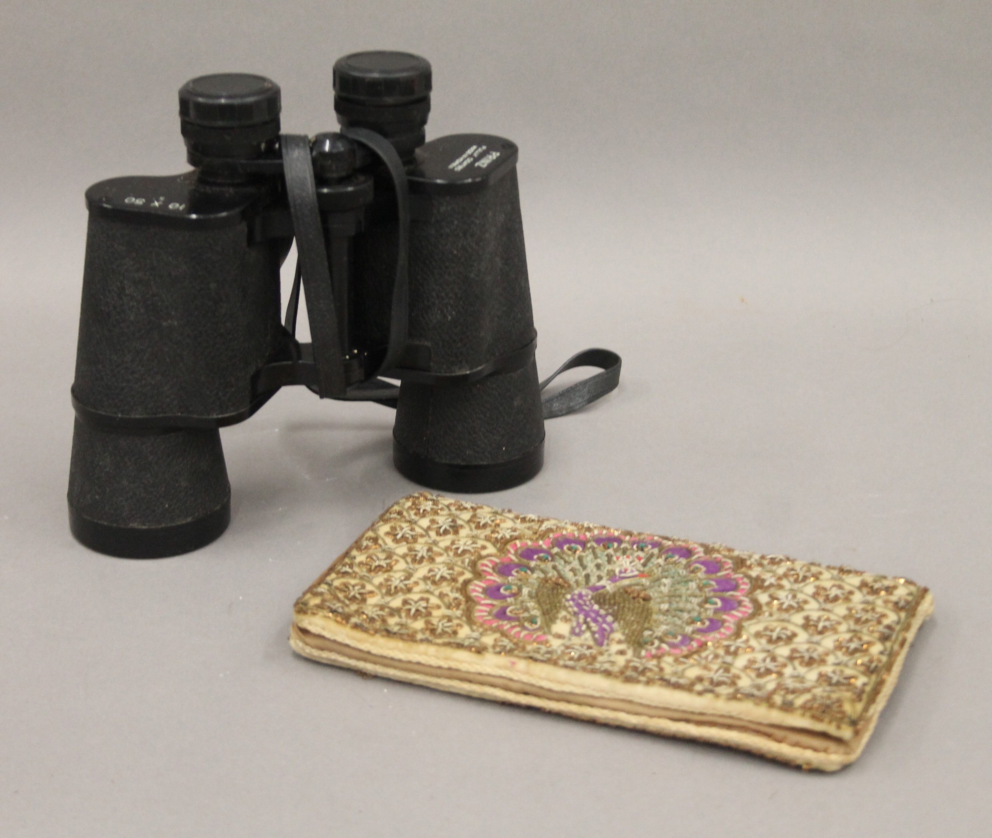 An Indian embroidered purse and a cased pair of binoculars. The former 20 cm wide.