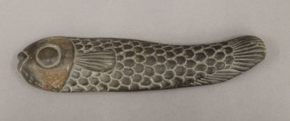 An Eastern carved stone model of a fish. 21 cm long.