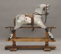 A vintage F H Ayres dapple grey painted carved wooden rocking horse. 106 cm long.