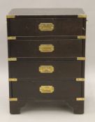 A small Campaign style chest of drawers. 46 cm wide x 62 cm high.