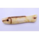 A small Chinese russet jade coloured fish, Shang Dynasty. 7.5 cm long.