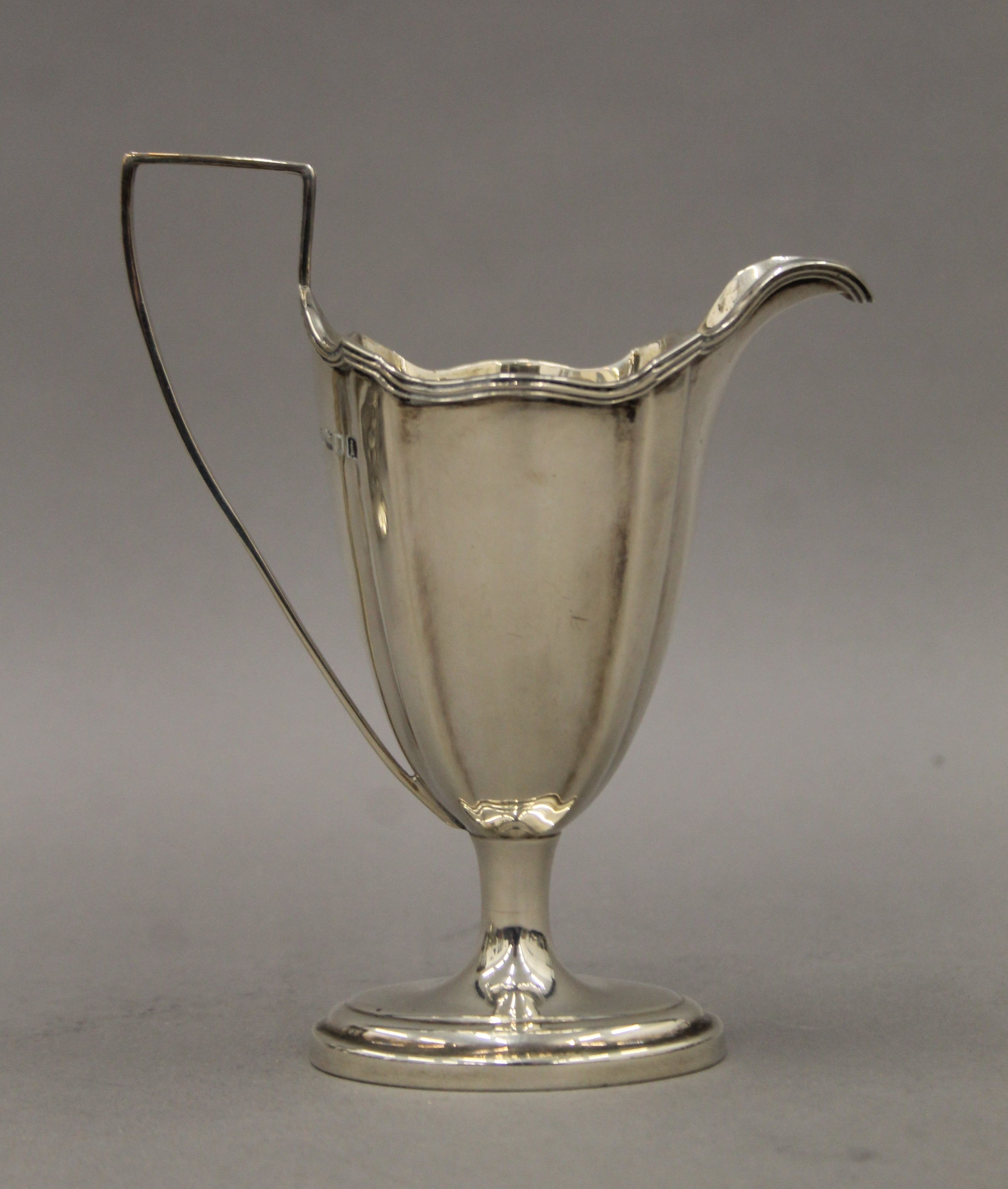 An associated three piece silver tea set, the teapot bearing description. 26.5 cm long. 684. - Image 11 of 13