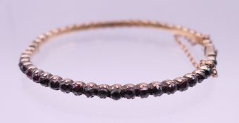 An antique cut garnet bangle.