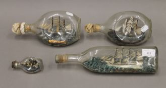 Four vintage ship in bottle models. The largest 30.5 cm long.