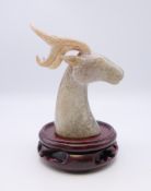 A Chinese white jade stags head, with modern wooden stand, Han Dynasty. The former 7.5 cm high.