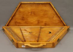 A hammered dulcimer in box. The box 97 cm long.