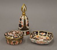 A Royal Crown Derby candle snuffer, a trinket box and a small dish. The former 12 cm high.