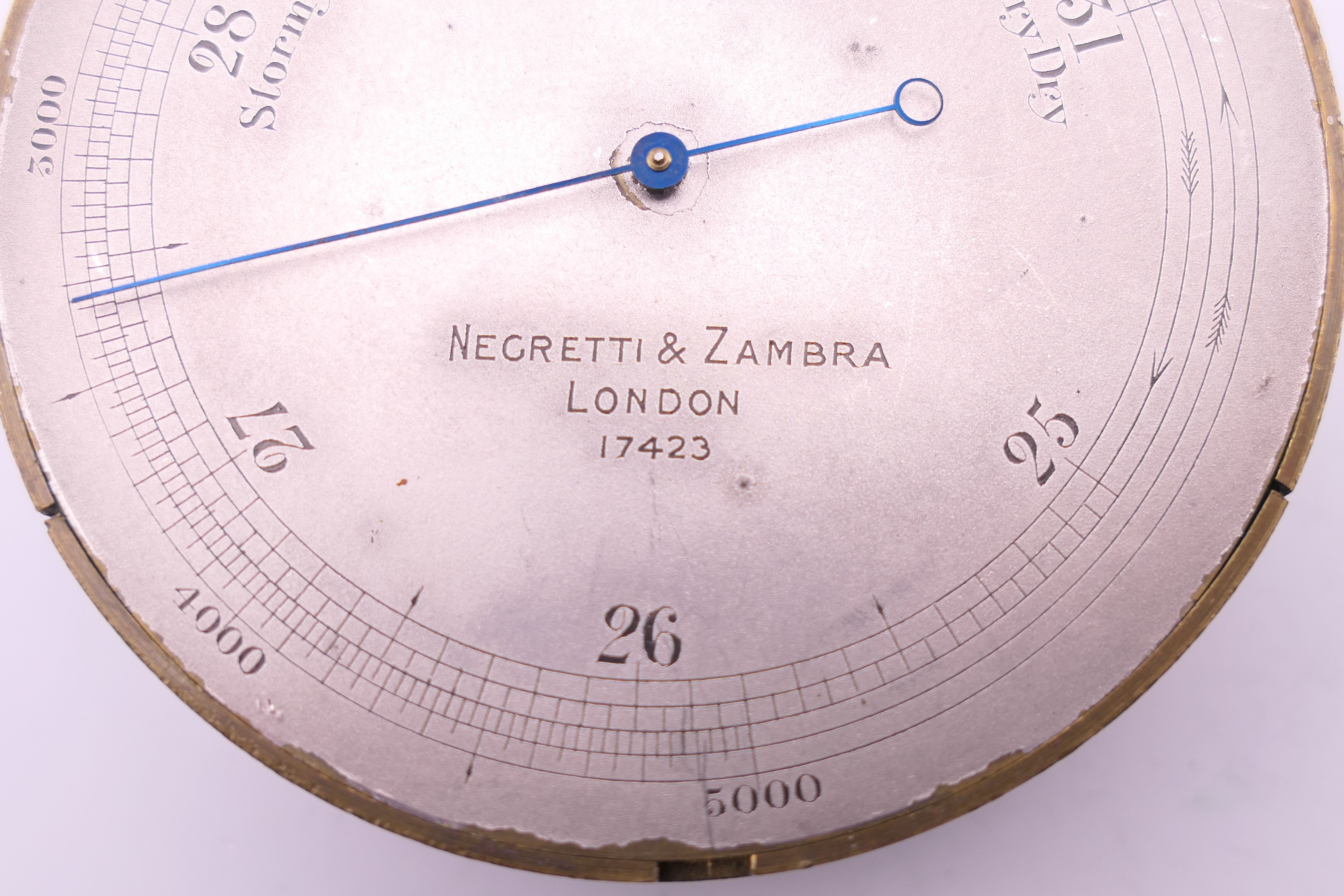 A Negretti & Zambra of London brass barometer, in original case, numbered 17423. 7 cm diameter. - Image 10 of 15