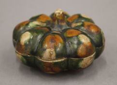 A small Chinese Sancai lidded pot in the shape of a pumpkin, Tang Dynasty. 7 cm diameter.