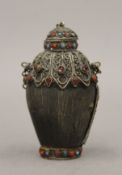 A Tibetan horn snuff bottle. 8 cm high.