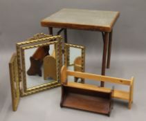 A folding card table, a triptych mirror and two book racks. The former 61 cm wide.