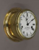 A brass bulk head clock. 19 cm diameter.