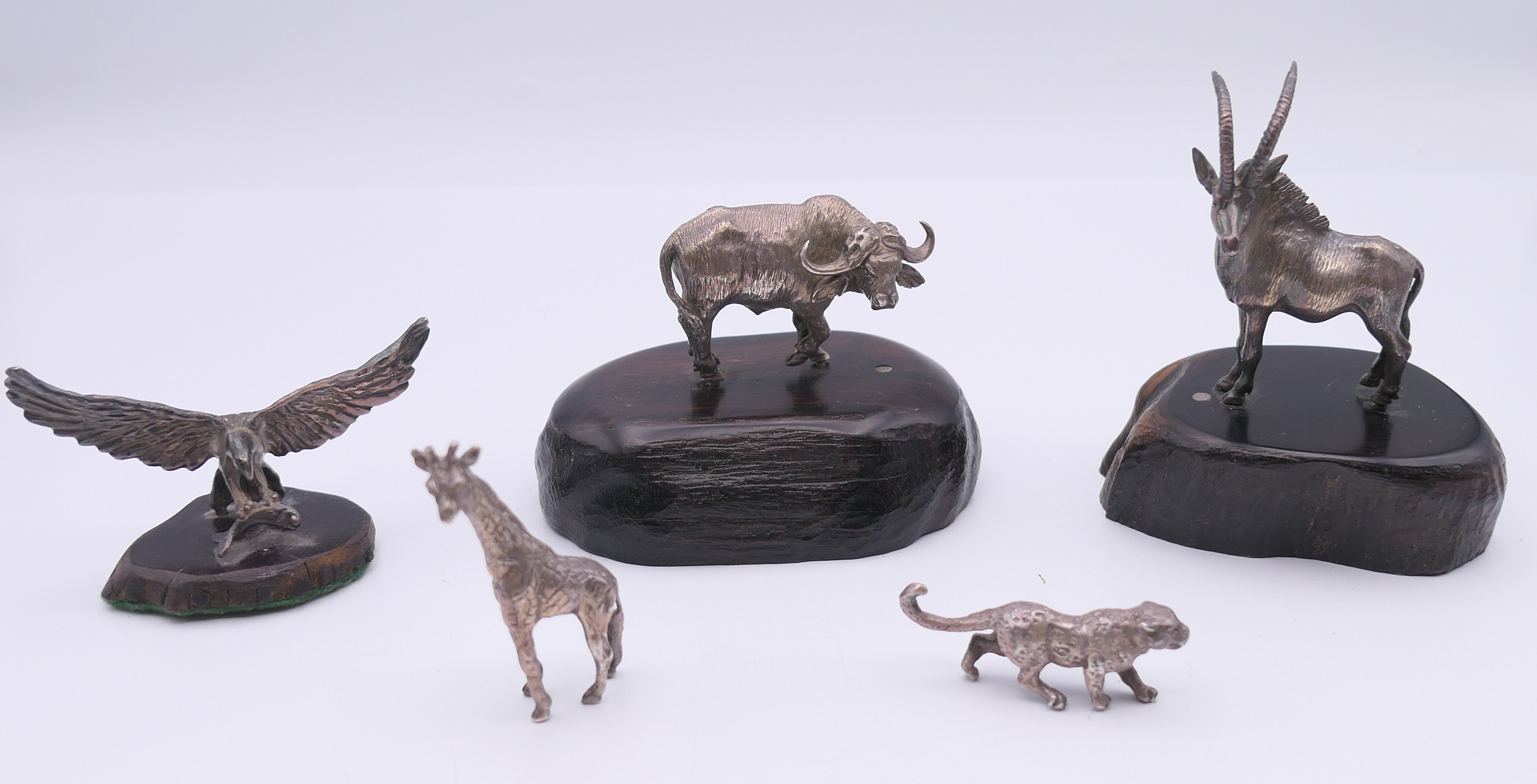 Five Patrick Mavros small silver model animals, three mounted on wooden plinth bases. The largest 8.