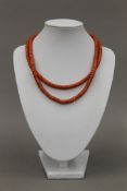 An 18 ct gold mounted two strand coral necklace. Approximately 40 cm long. 57.