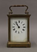 A Victorian brass cased carriage clock in original carrying case. The clock 14 cm high.