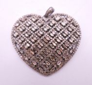 A diamond heart pendant. 4 cm wide.