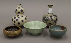Five pieces of Asian pottery. The largest 11 cm high. Provenance: The Larkin/Minney Collection.