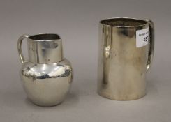 A silver Christening mug and a silver cream jug. The former 9.5 cm high. 256.7 grammes.