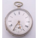 A silver open face pocket watch, hallmarked Chester 1892, serial number 1014. 4.5 cm diameter.