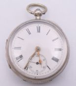 A silver open face pocket watch, hallmarked Chester 1892, serial number 1014. 4.5 cm diameter.