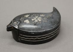 A Persian metal box with silver inlay. 8 cm long.