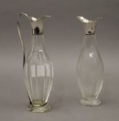 A pair of cut glass unmarked silver topped vinaigrettes. The largest 16.5 cm high.