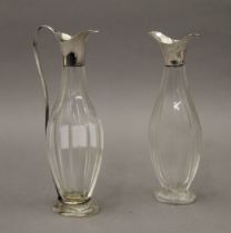 A pair of cut glass unmarked silver topped vinaigrettes. The largest 16.5 cm high.