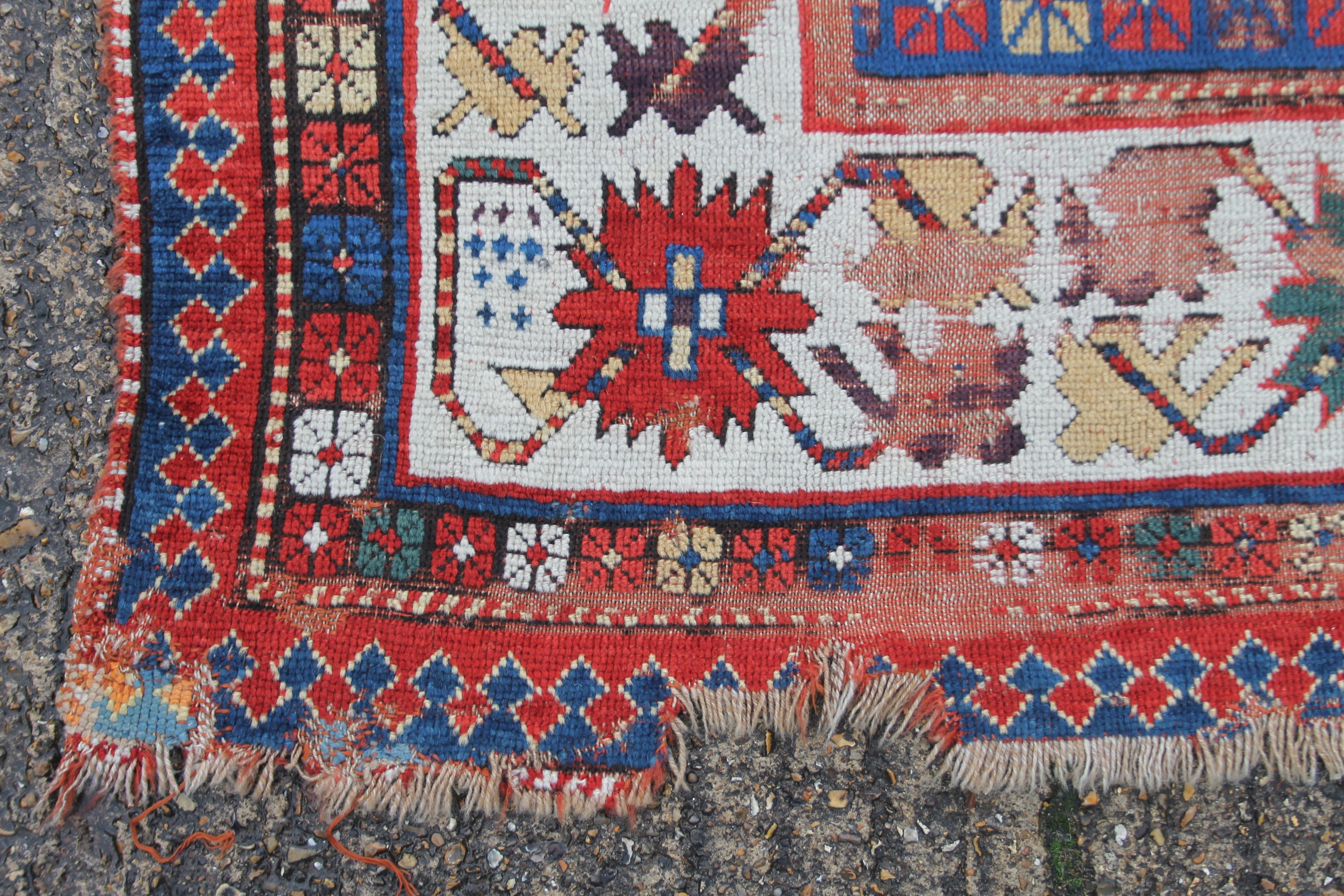 A Caucasian red ground wool rug. 142 x 220 cm. - Image 2 of 3