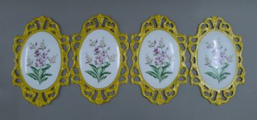 A set of four florally decorated porcelain plaques. 34.5 cm high.