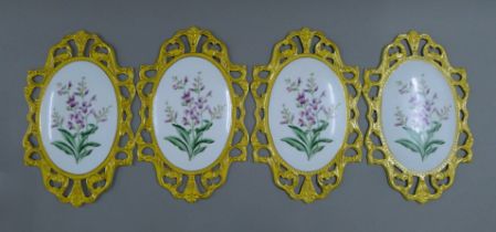 A set of four florally decorated porcelain plaques. 34.5 cm high.
